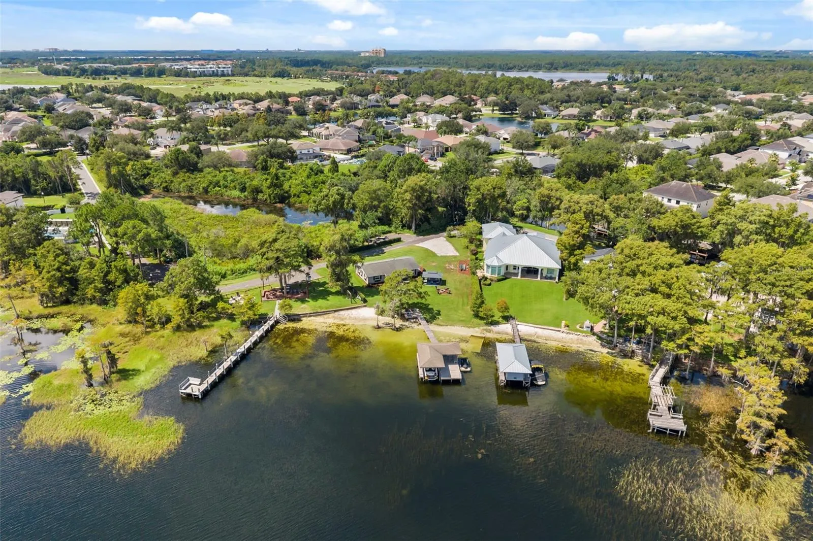 An exceptional opportunity to own one of the most compelling lakefront properties on Lake Cottage Lane, featuring an oversized homesite, expansive Lake Sheen views, sandy shoreline, private dock and boatlift, and an existing 2BR/1.5BA lake cottage that can be enjoyed today while you plan the lakefront estate of your dreams.