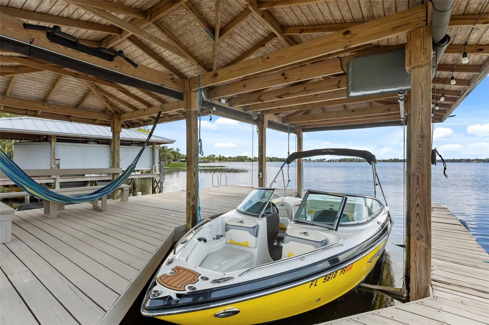 A private dock and boatlift provide immediate access to Lake Sheen and the entire Butler Chain, while a gated community boat ramp is approximately 300 feet away.
