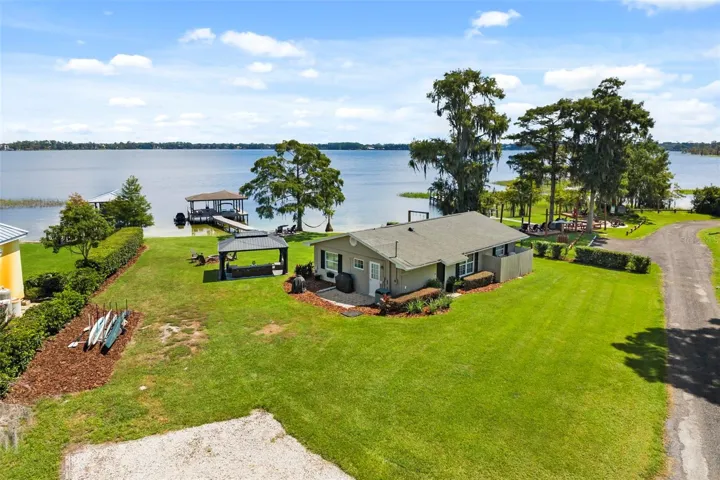 Lake Cottage Lane, featuring an oversized homesite, expansive Lake Sheen views, sandy shoreline, private dock and boatlift, and an existing 2BR/1.5BA lake cottage that can be enjoyed today while you plan the lakefront estate of your dreams.