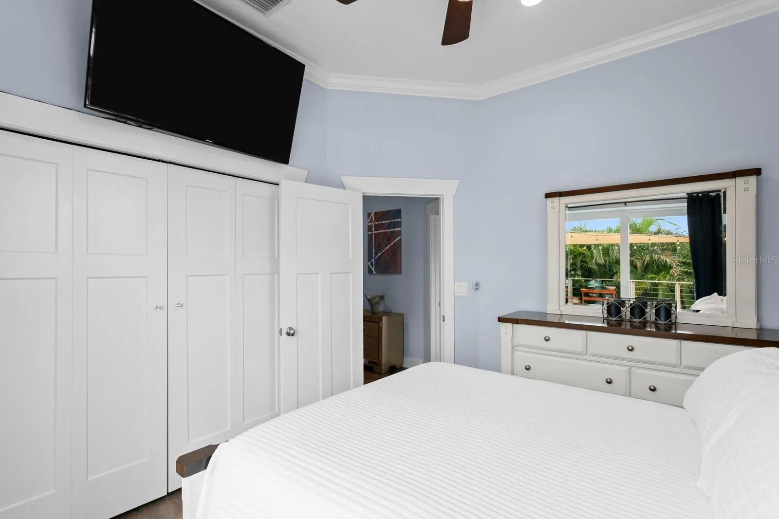 2nd bedroom with ceiling fan and built-in closet