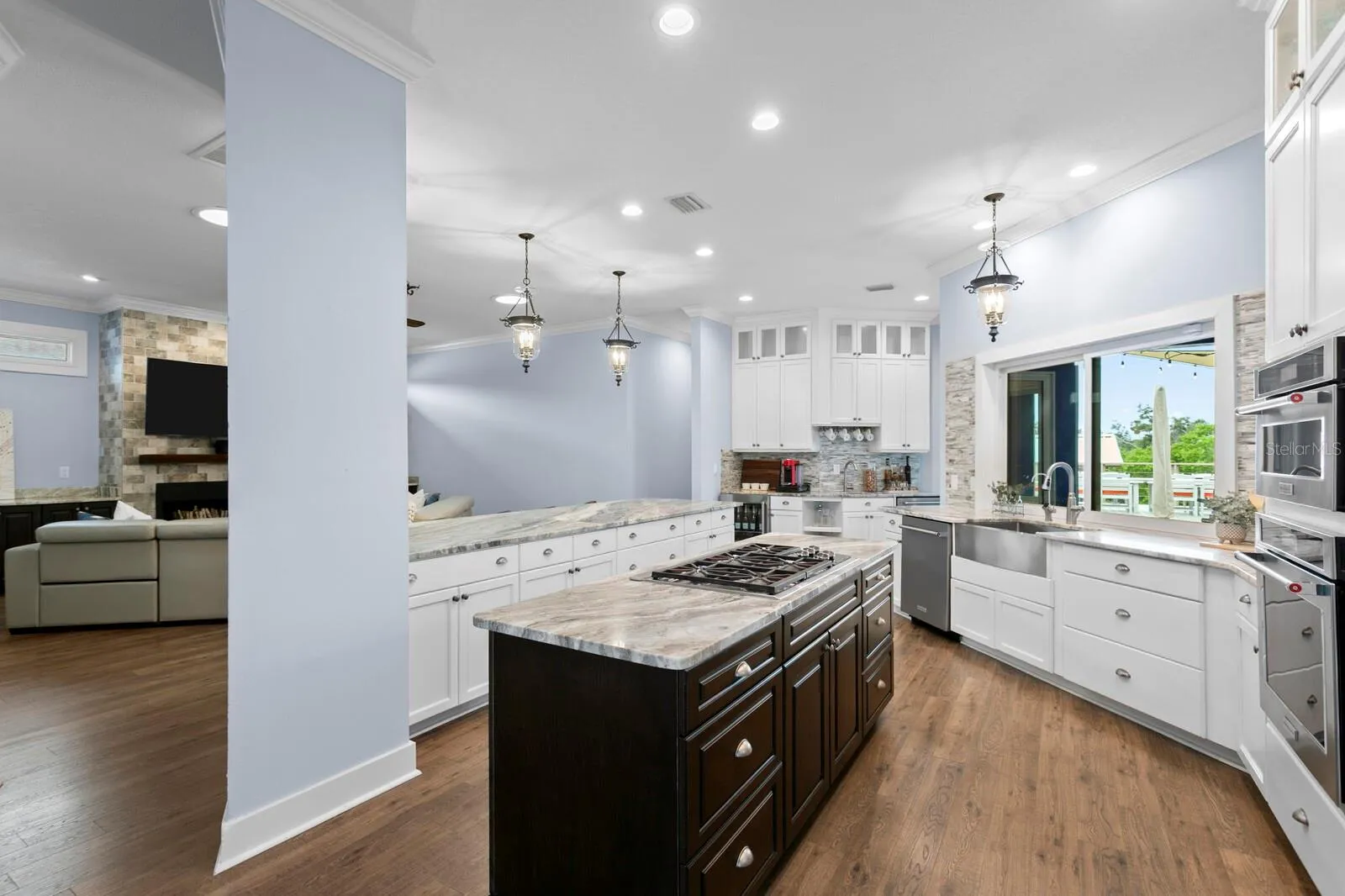 Large gourmet Kitchen with two islands and coffee/wet bar opens to Family Room