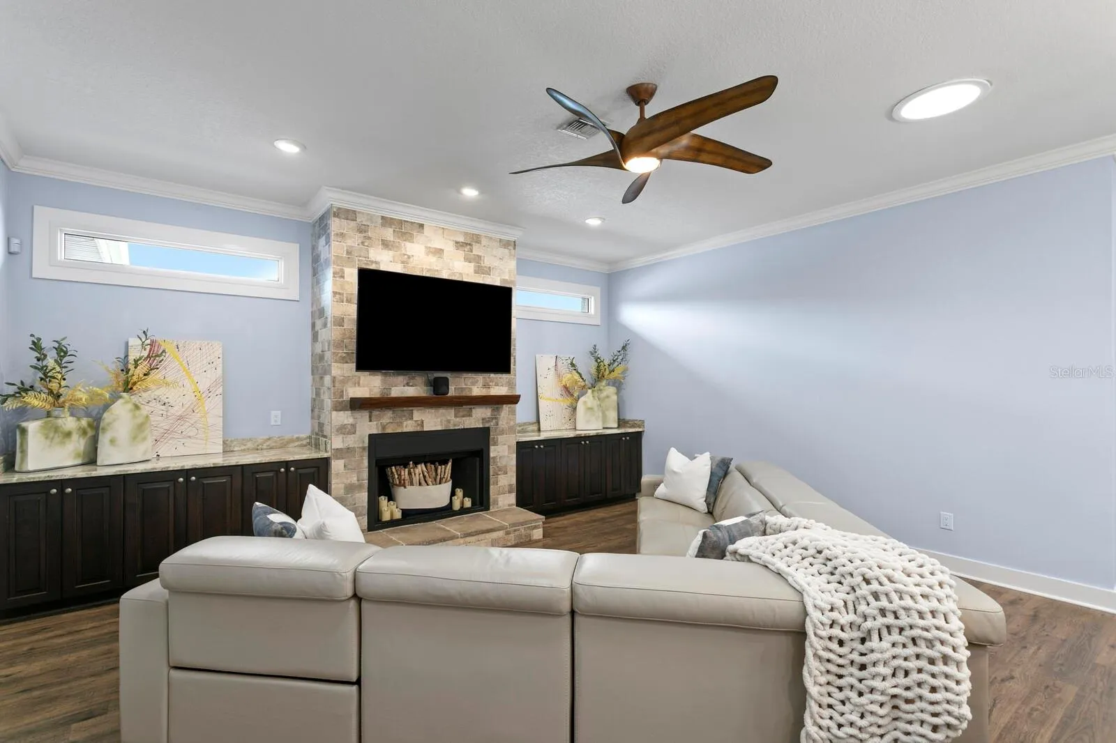 Family room features custom built in cabinets