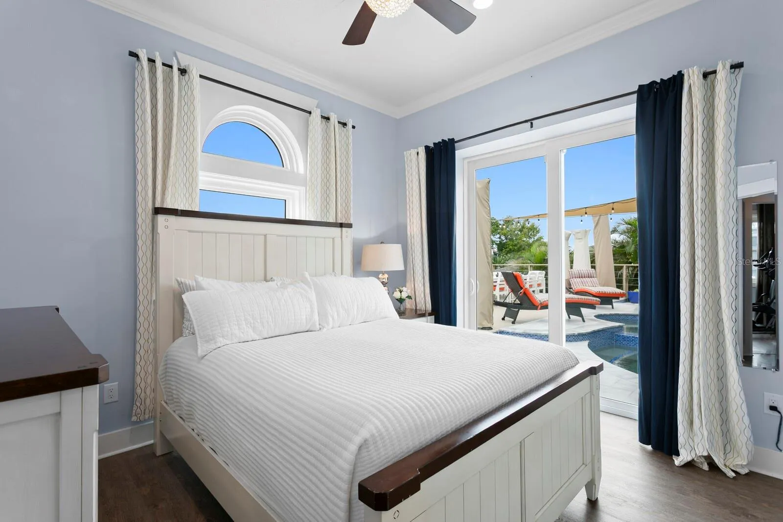2nd bedroom with dual pocket sliding impact door leading to pool