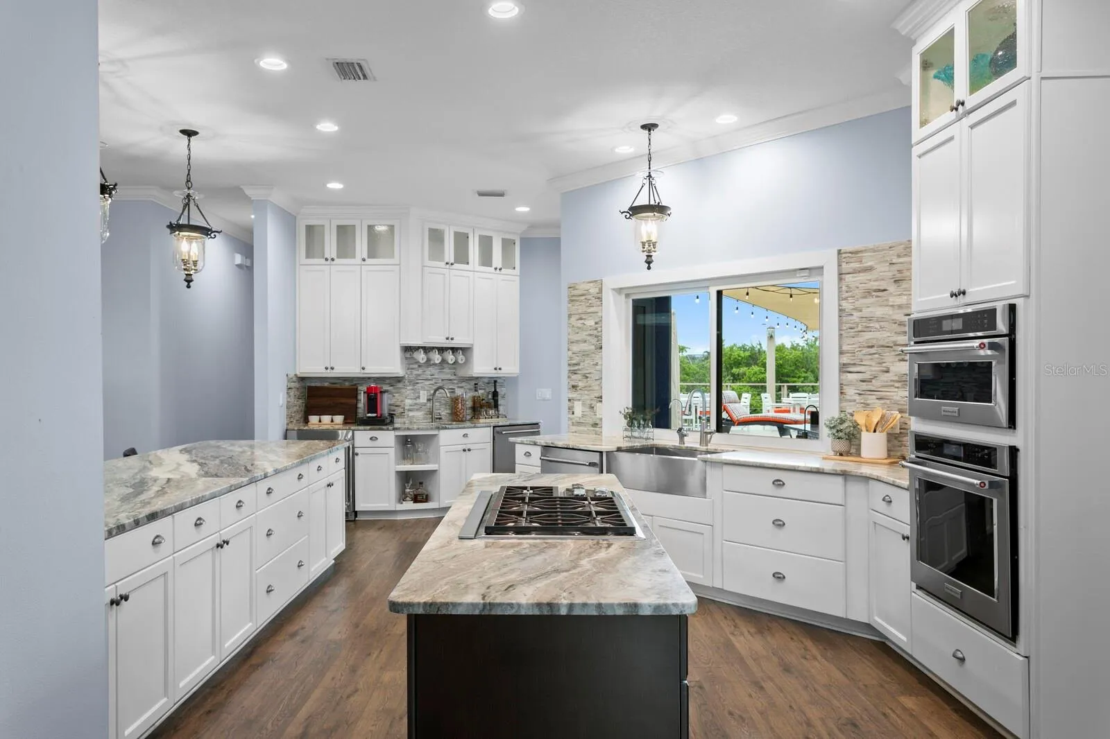 Kitchen features all stainless steel appliances, large farm sink and two dishwashers