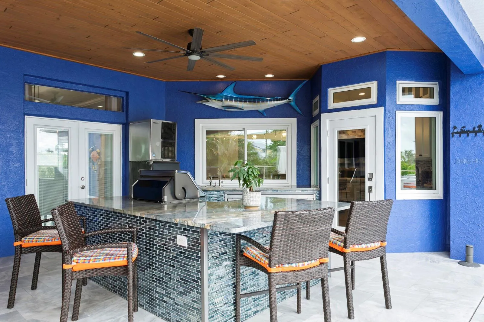 Custom outdoor kitchen with granite counters and breakfast bar