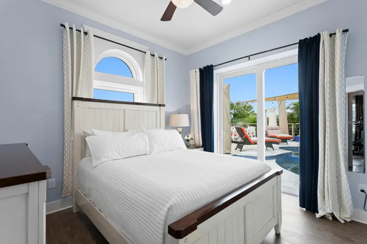 2nd bedroom with dual pocket sliding impact door leading to pool