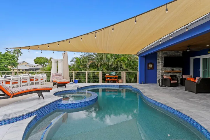 Redesigned pool with pebble tec and heated/polar plunge spa with infinity edge