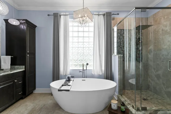 Ensuite bath features garden tub, frameless walk-in shower with dua shower heads