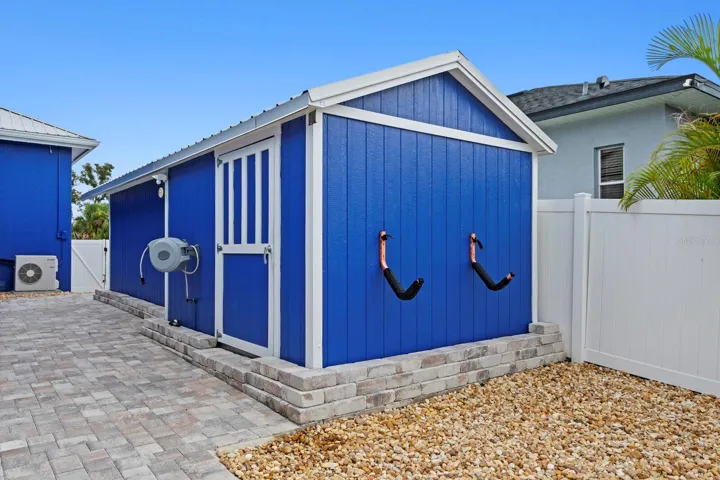 Large storage shed is attached to workshop which includes electricity and air conditioning