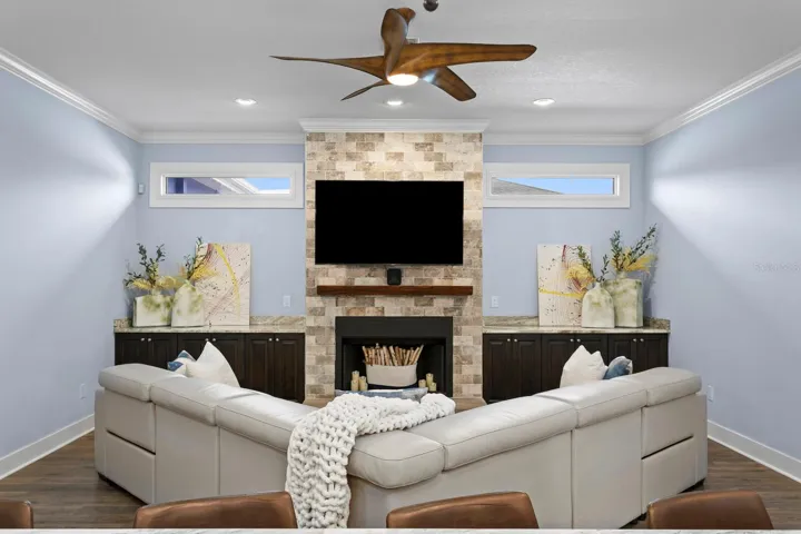 Family Room features dual transom lights, wood burning fireplace, and granite counters