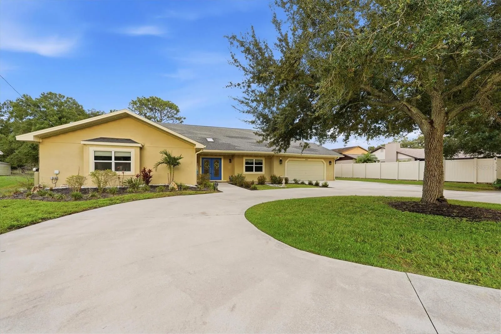 Oversized parking pad and circular driveway can accommodate numerous vehicles.