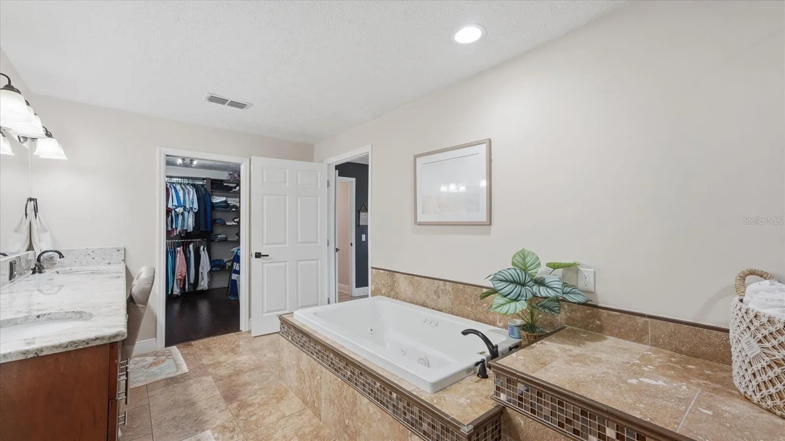 Soak in the jetted tub after a long day! Roomy walk-in closet features built-in custom closet system