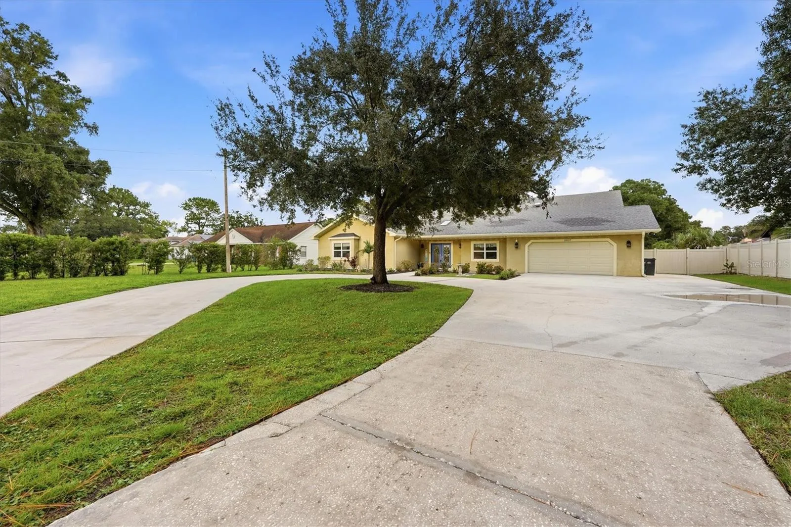 Oversized driveway offers a large parking pad to the right for storing an RV, boat or larger vehicle without blocking the garage.