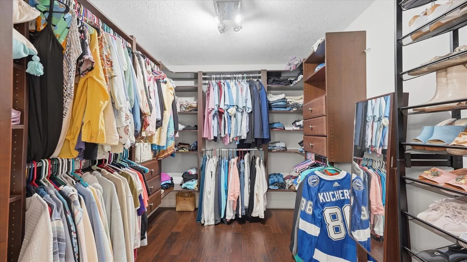 Primary bedroom offers custom built in closet organizer