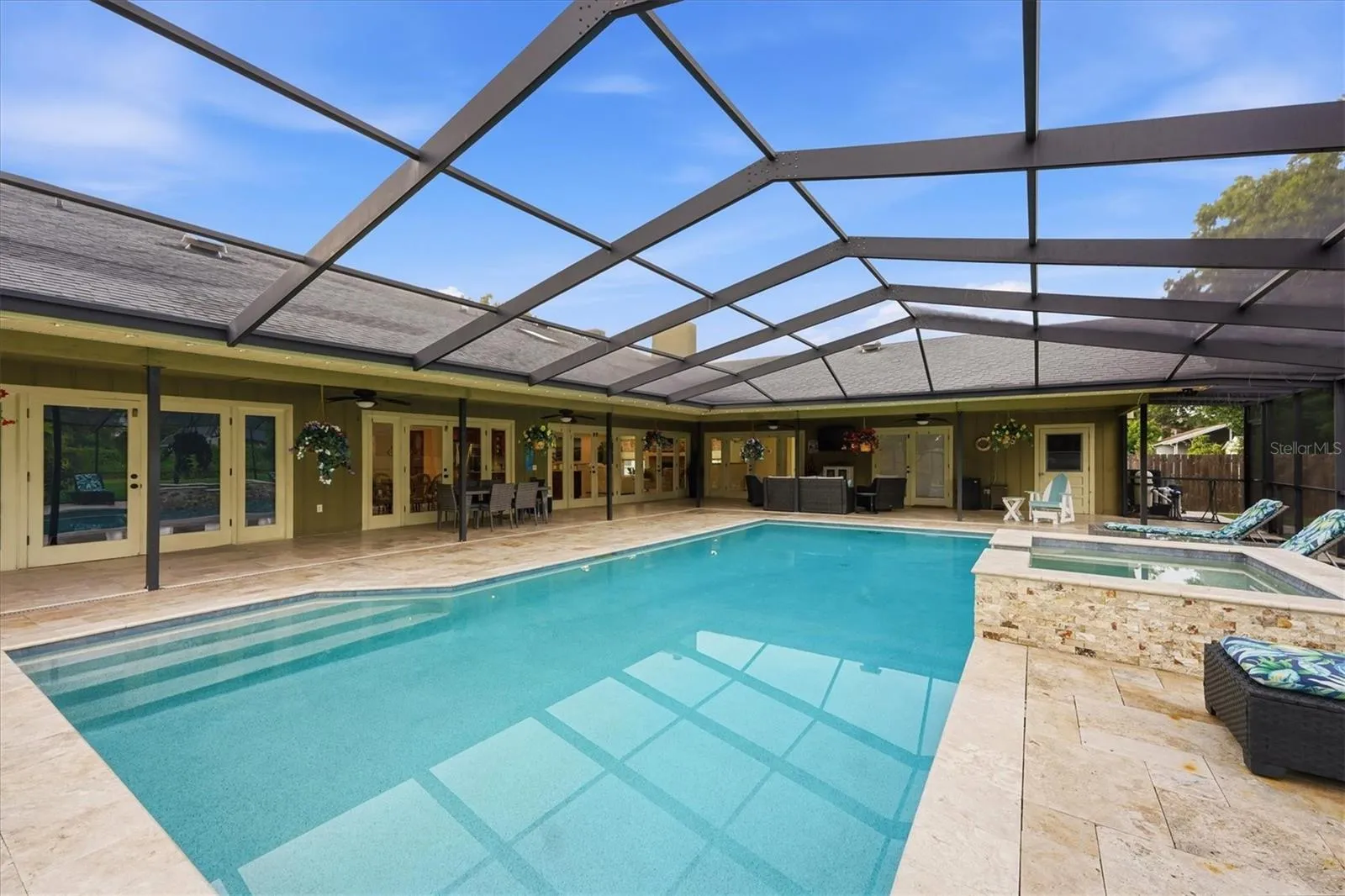 Full view of back of house and covered patio areas.