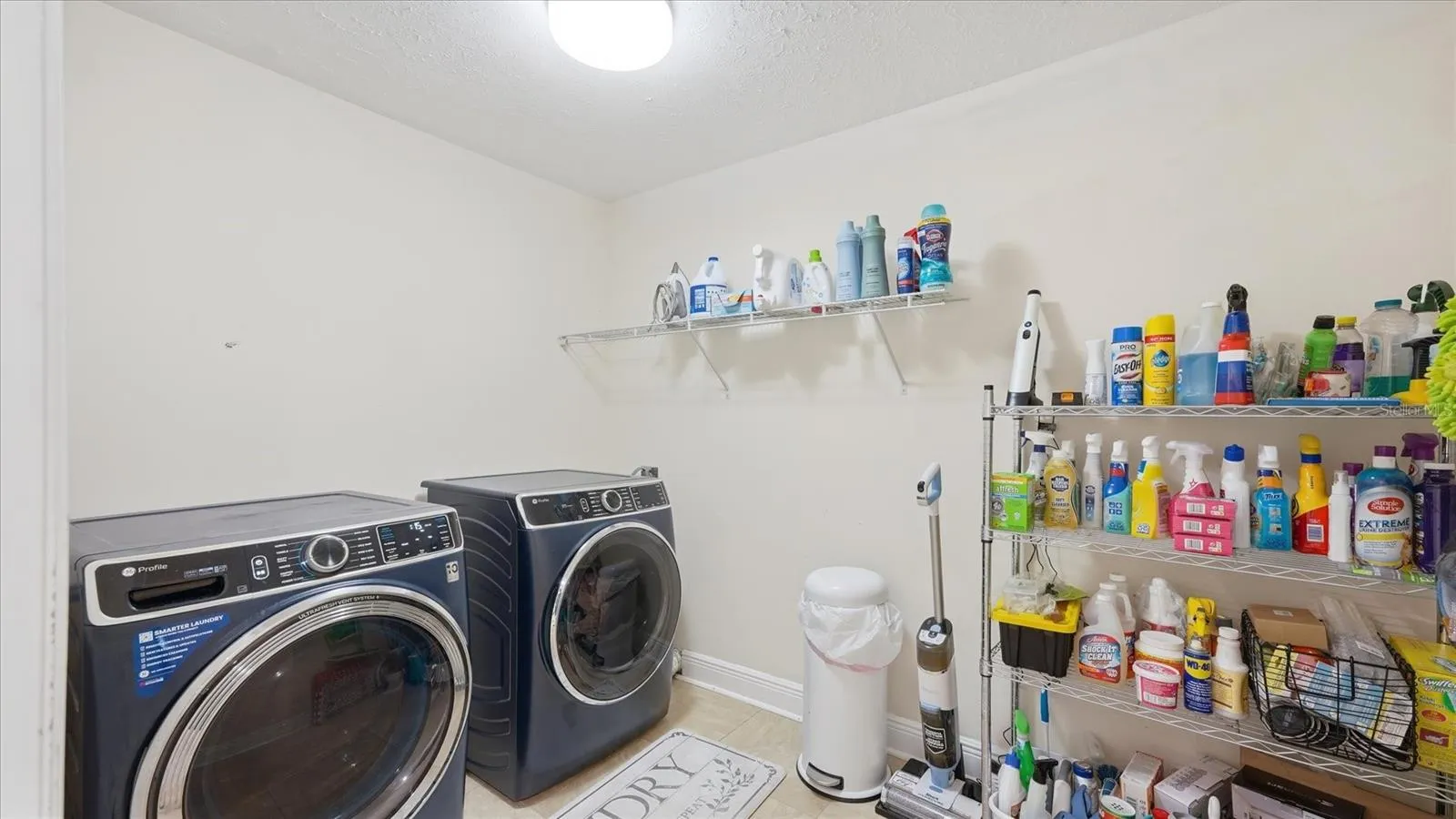Laundry Room comes with newer (2024) Front Load GE Profile W/D and offers extra storage space