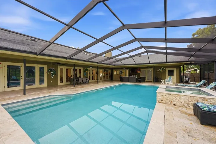 Full view of back of house and covered patio areas.