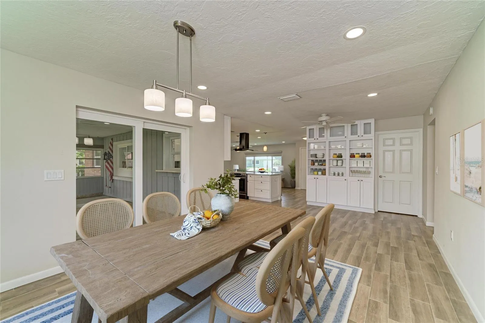 Virtually staged. Large dining room off the kitchen with built-in shelves and cabinets.