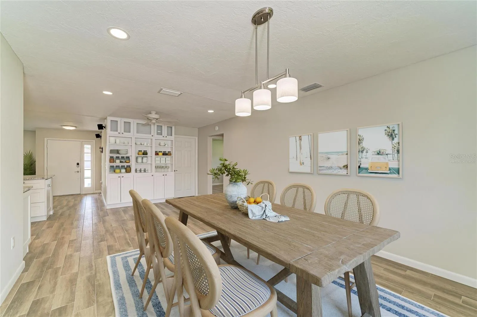 Virtually staged. Large dining room off the kitchen with built-in shelves and cabinets.