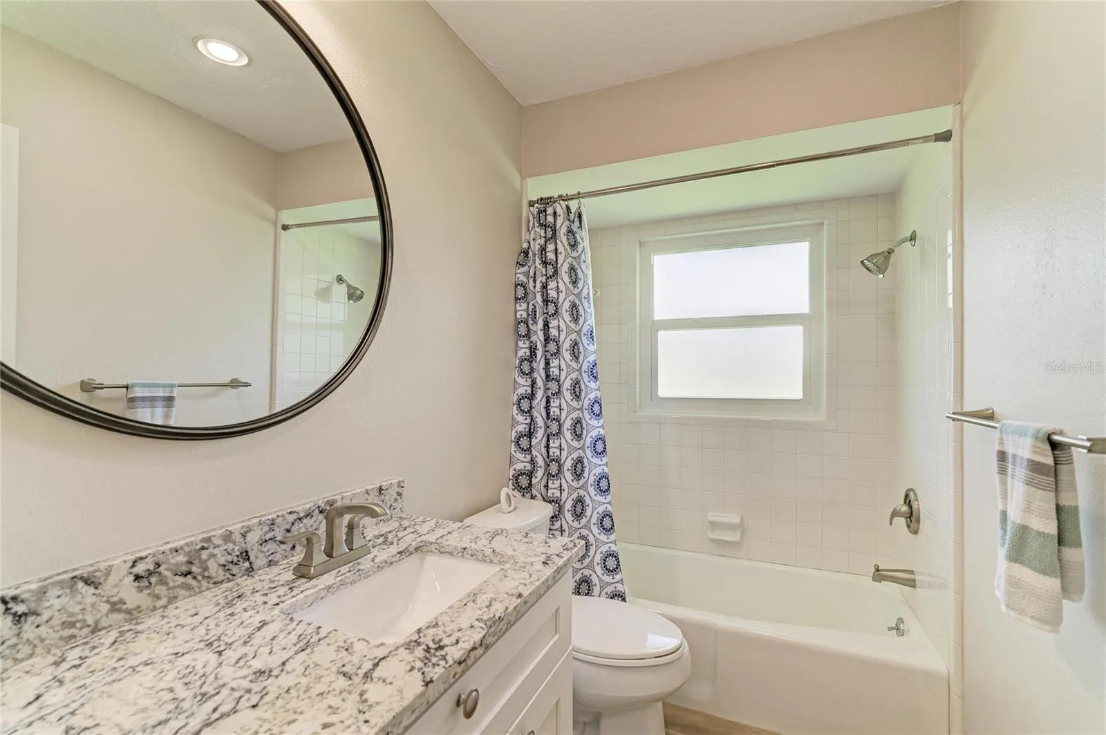 Updated guest bathroom with granite counter.