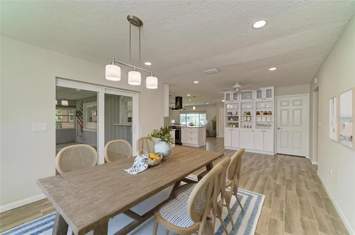 Virtually staged. Large dining room off the kitchen with built-in shelves and cabinets.