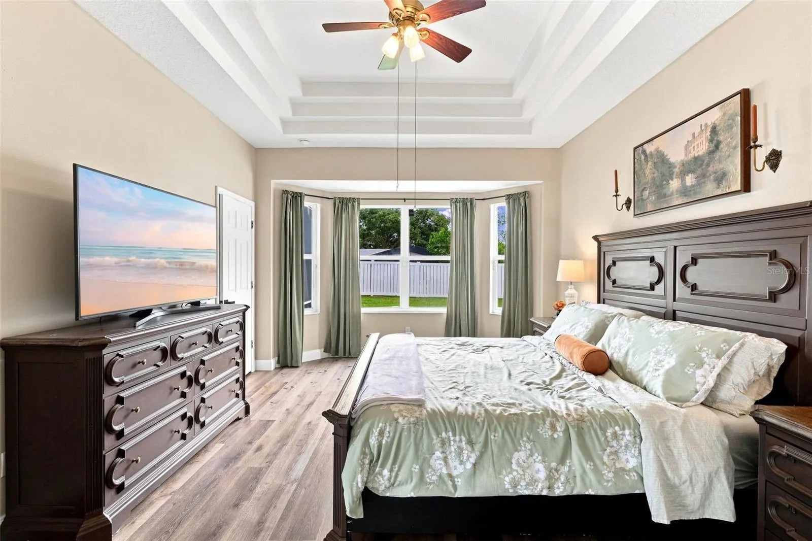Primary bedroom with bay window view.