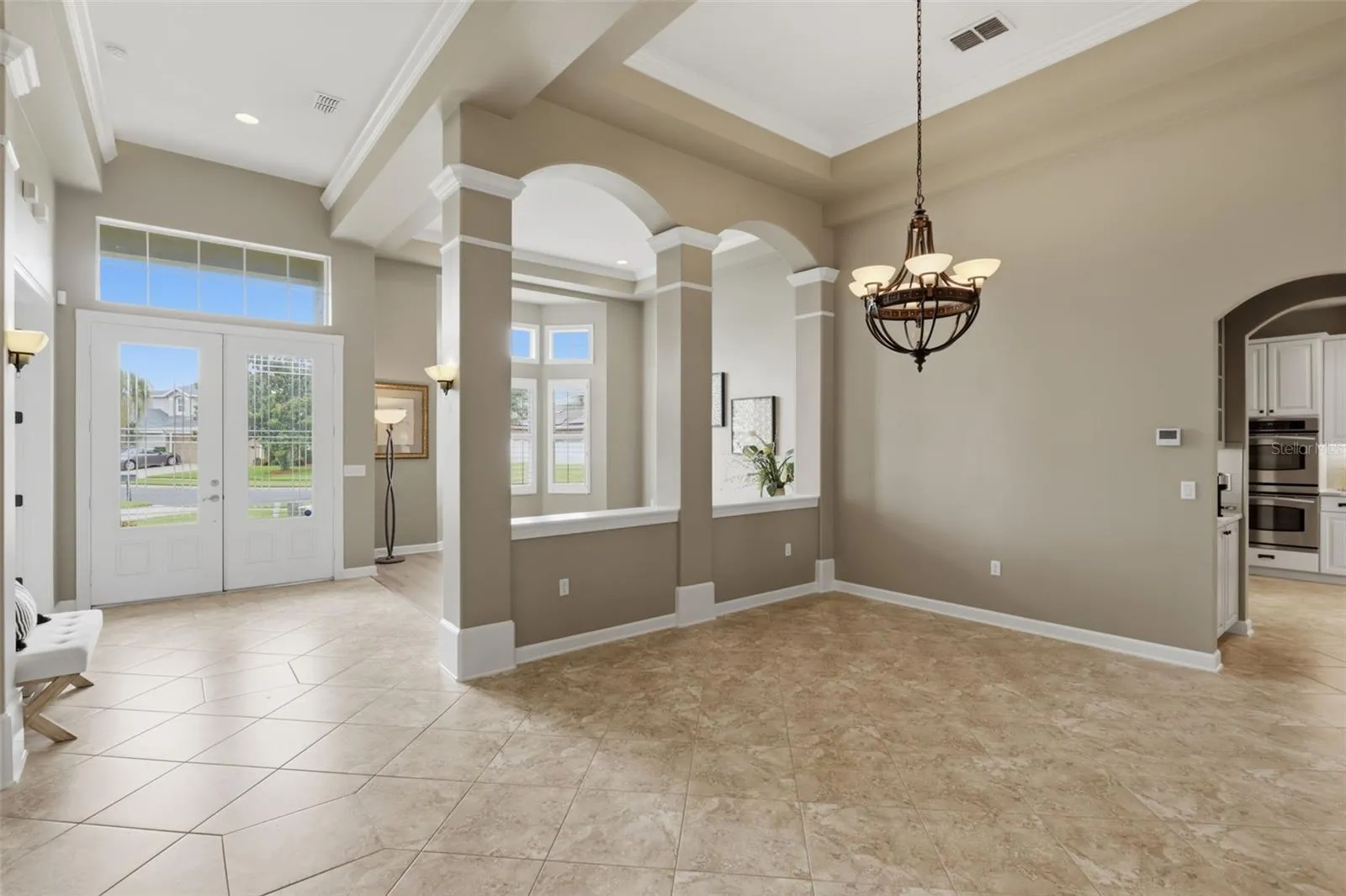 Foyer with scones and overhead ambient lighting.