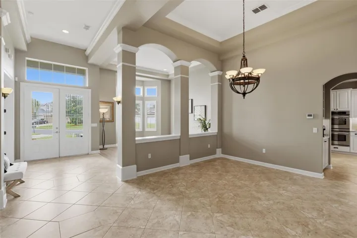 Foyer with scones and overhead ambient lighting.