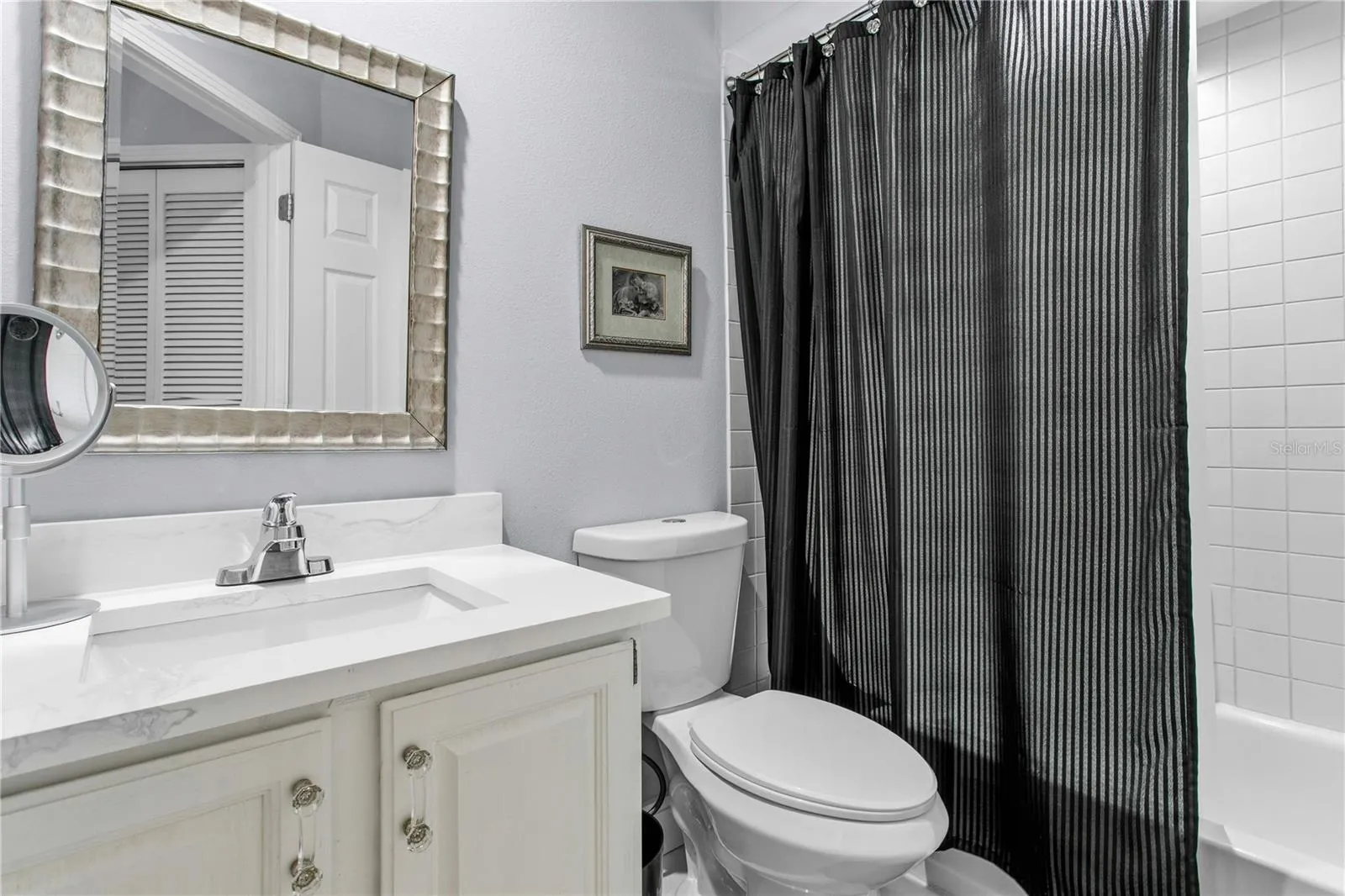 The en-suite bath is neatly designed for comfort, privacy, and ease.