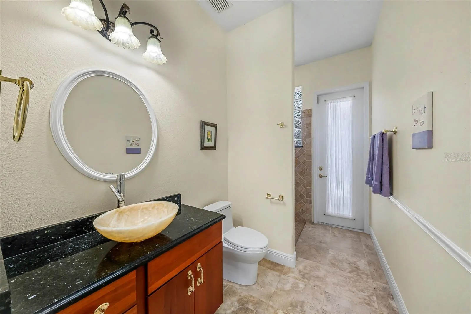 Hall bath looking toward door to courtyard &amp; entry from the office (not virtually staged)