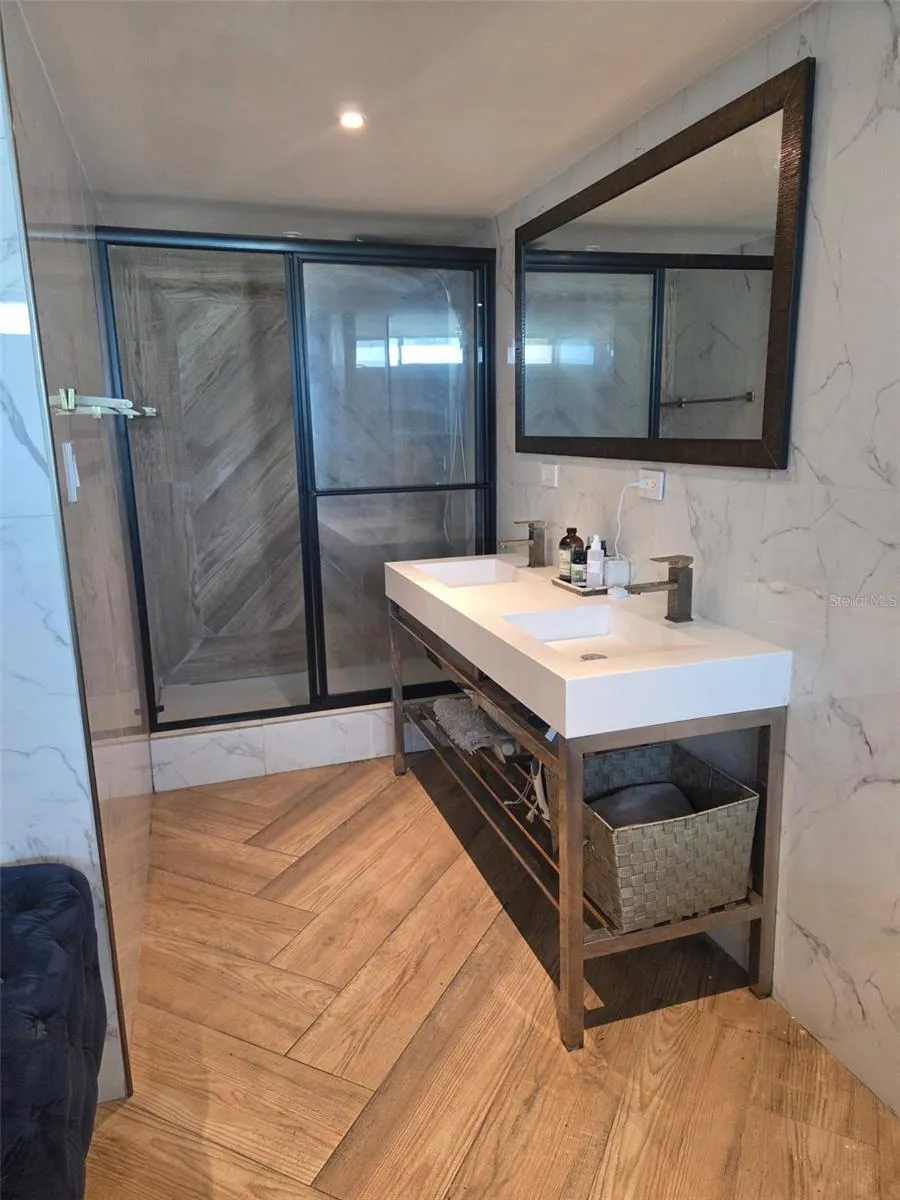 The double vanity and shower are in an alcove connected to the bedroom. The water closet is separate for more privacy.