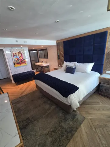 Bedroom has lots of room for a king bed and more... The vanity and shower are in the alcove to the rear right. The water closet is accessed through the door at the far left.