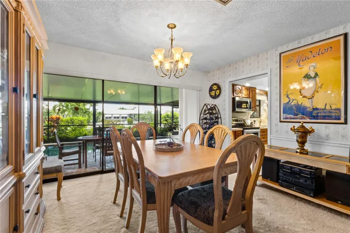 Dining Area with Slivers to the Covered Pool