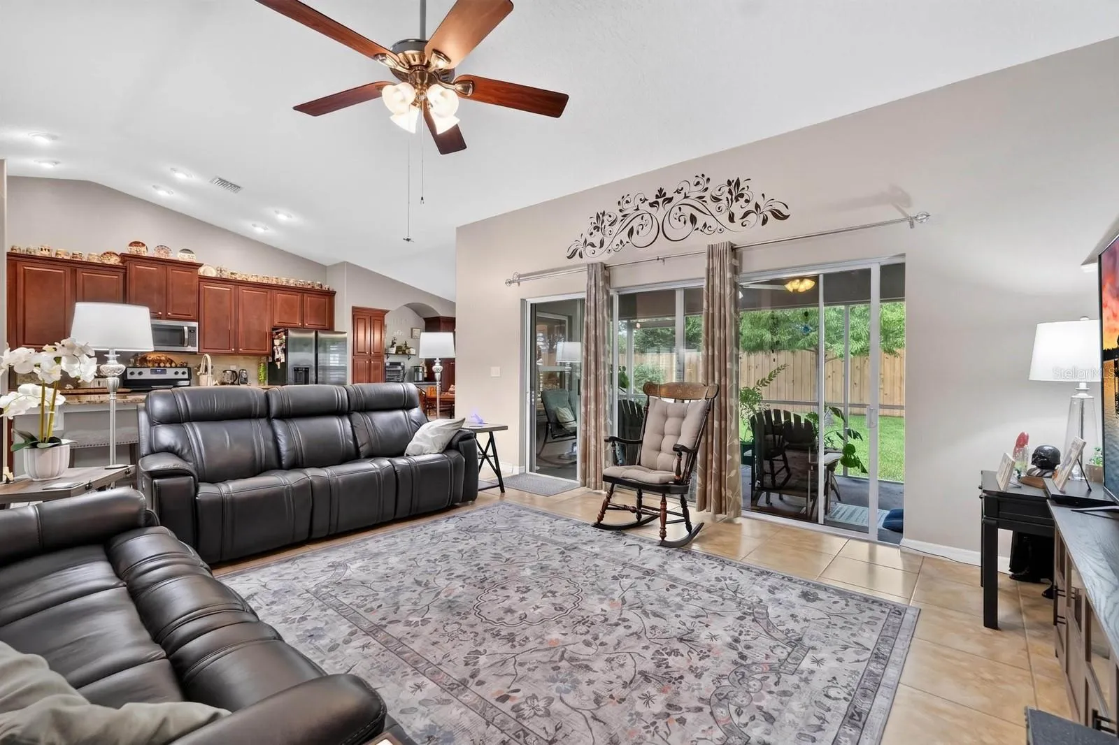 large sliding door opens up to covered screened lanai