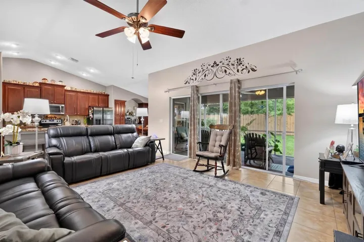 large sliding door opens up to covered screened lanai