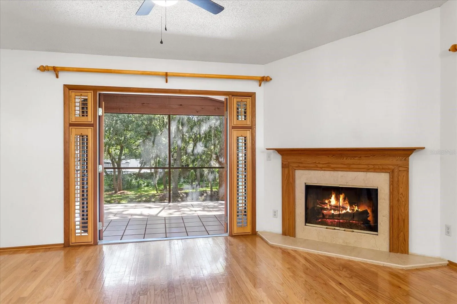 Beautiful fireplace next to french doors to porch