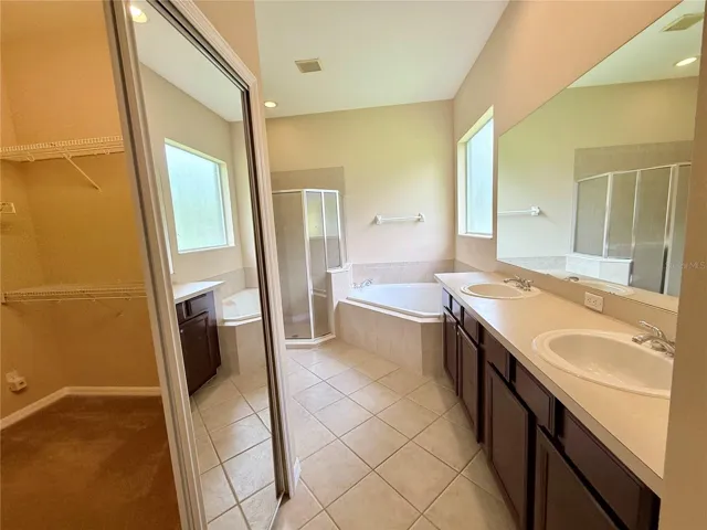 Master bathroom with large walk in closet