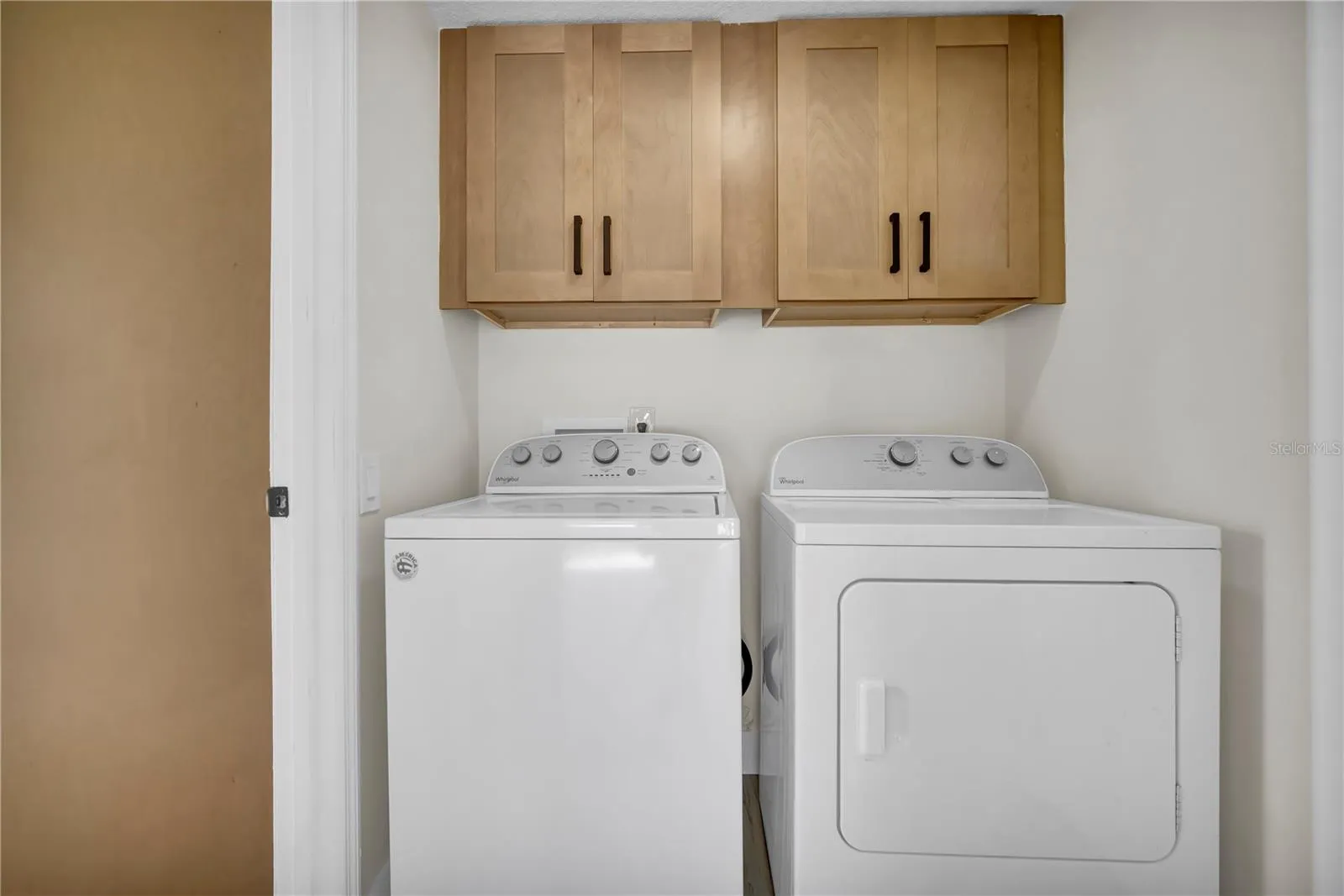 Attached laundry room with tons of storage.