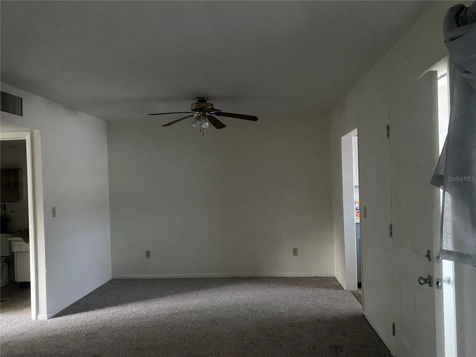 To the right of the living room is the dining area. New carpet & freshly painted. The opening on the right is into the kitchen. The open door to the left is the bathroom.