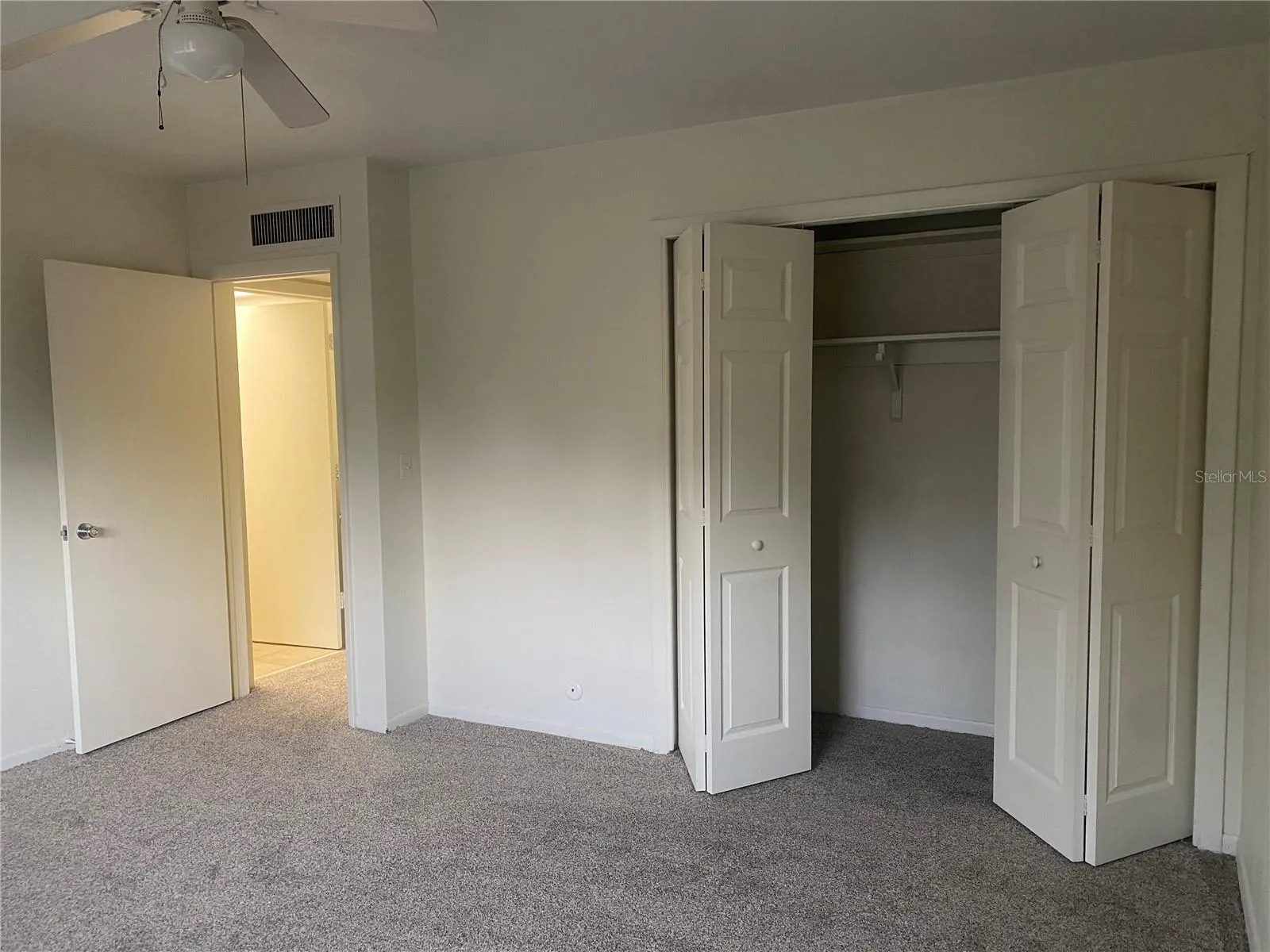 View of the wall-to-wall closet in the bedroom ( new carpet & freshly painted)