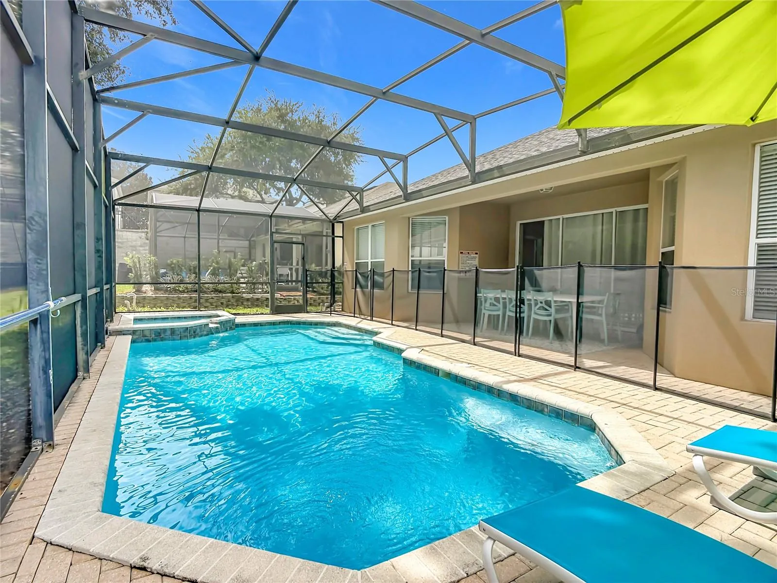 Heated pool and spa enclosed by an expansive screened lanai.
