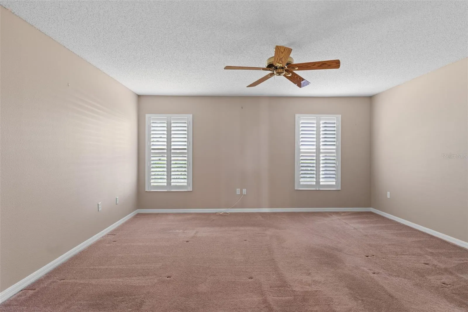Primary suite with plantation shutters.