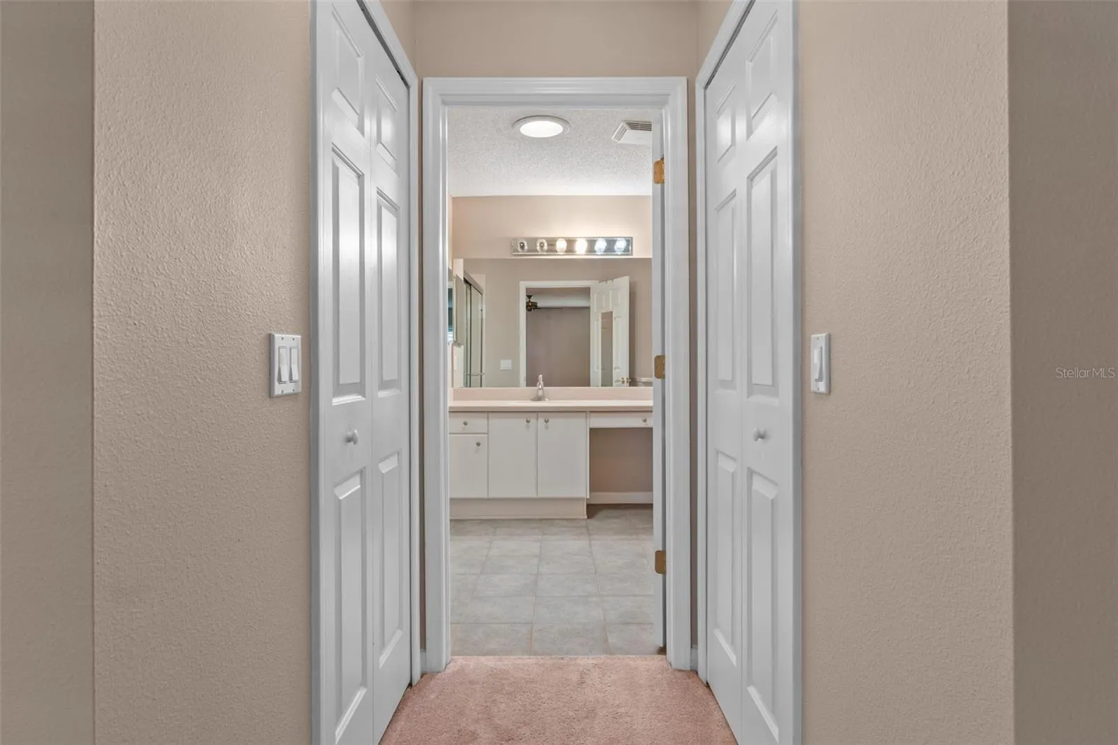 primary ensuite bath with walk in closets