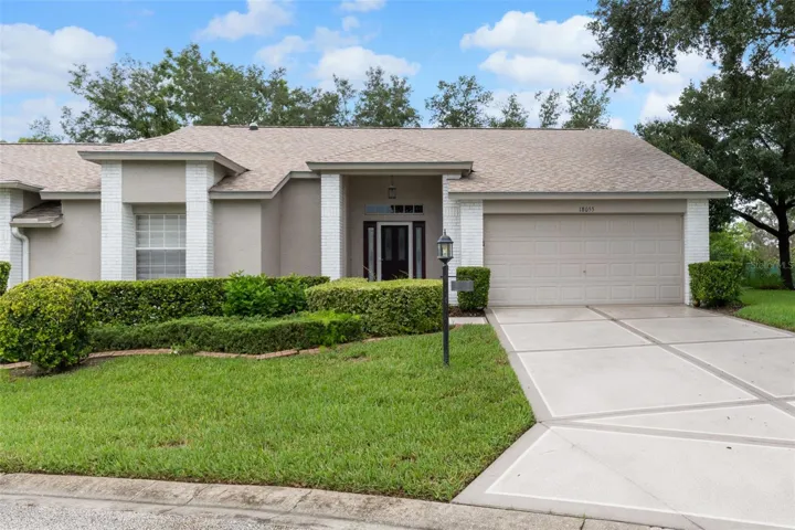 End-unit villa with 2-car garage in Heritage Pines.