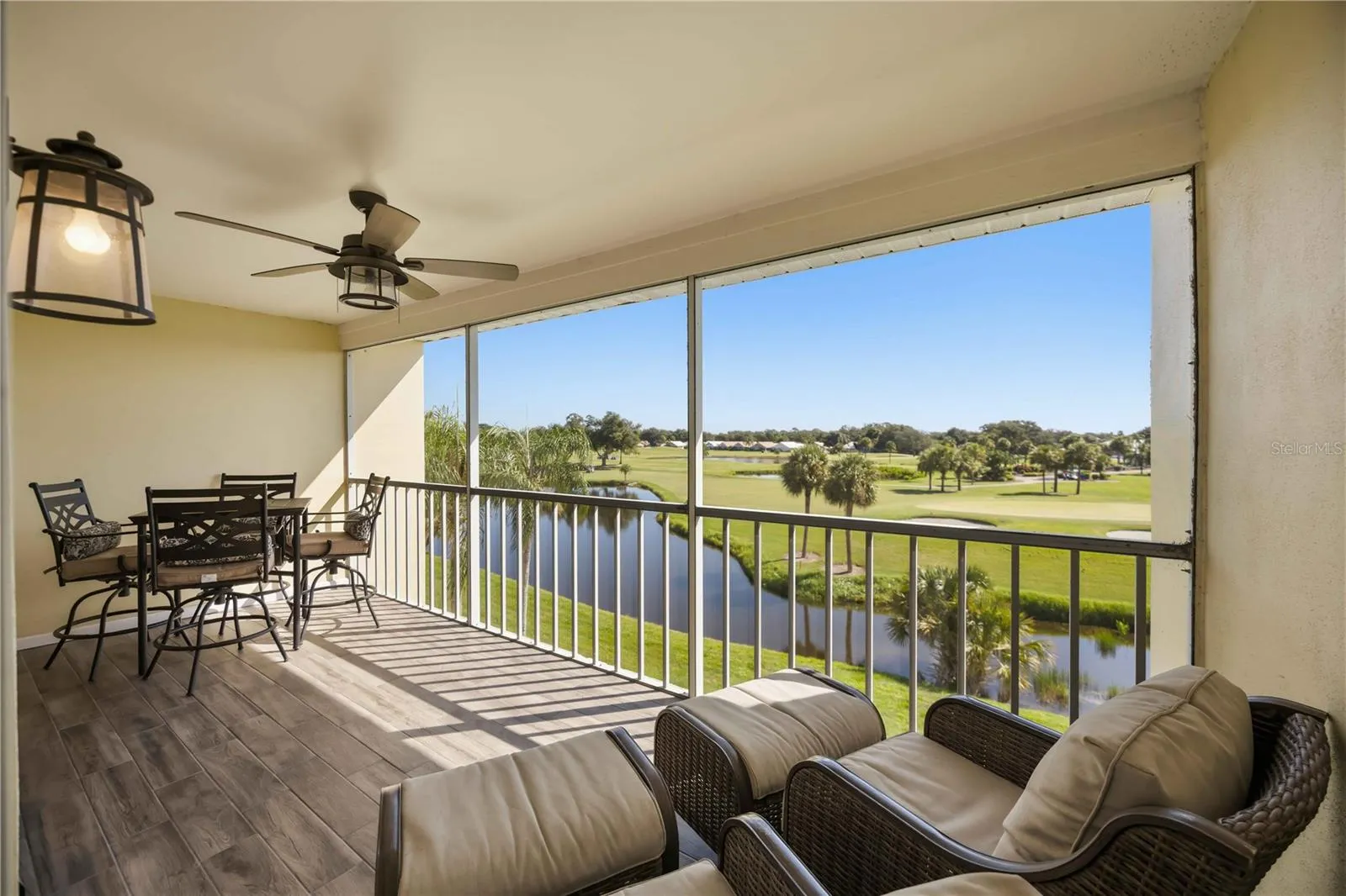 Expansive screened lanai offers a front-row seat to serene water and golf-course views.