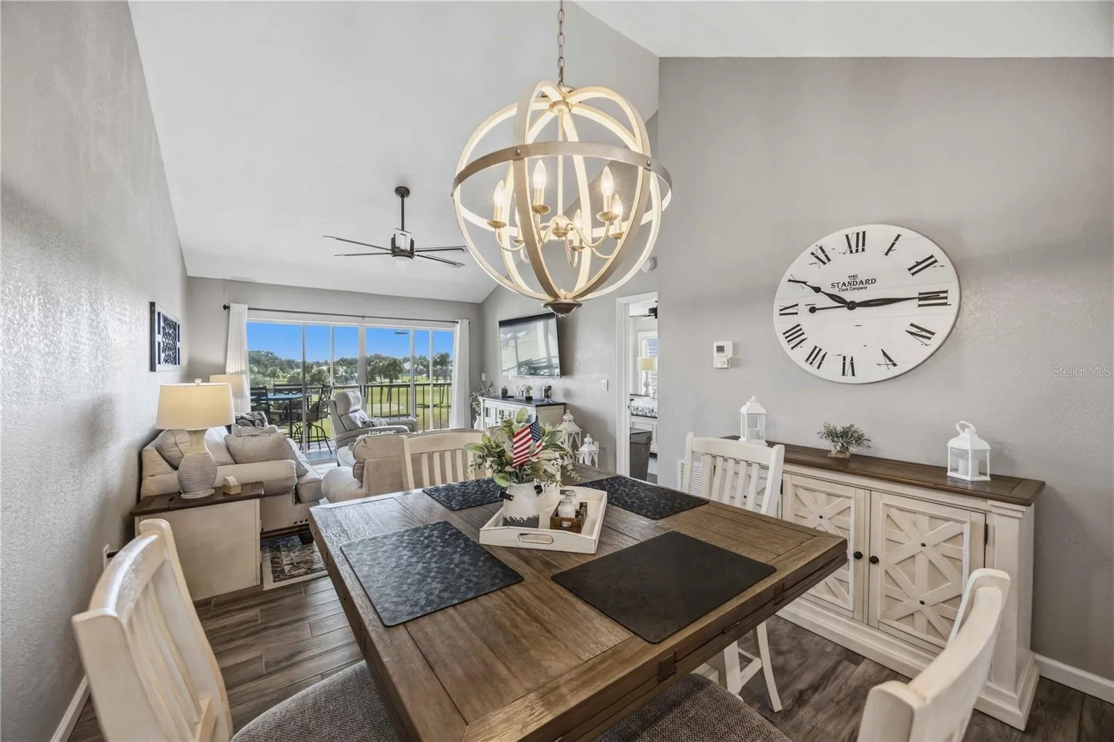 Open-concept living and dining spaces draw the eye toward expansive windows and the scenery beyond.