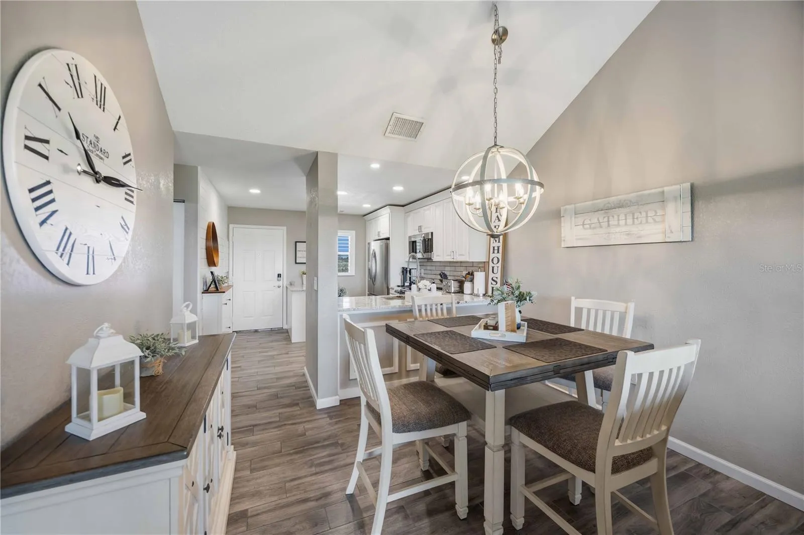 Light-filled dining space features vaulted ceilings and an eye-catching contemporary chandelier.