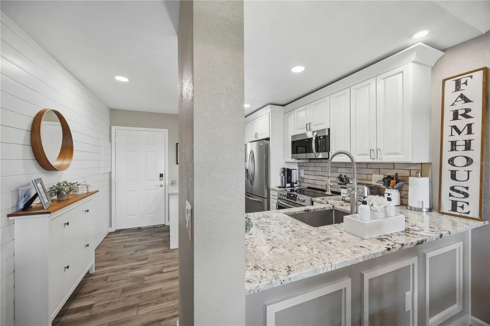 Spacious kitchen offers abundant cabinetry, granite countertops and stainless steel appliances.