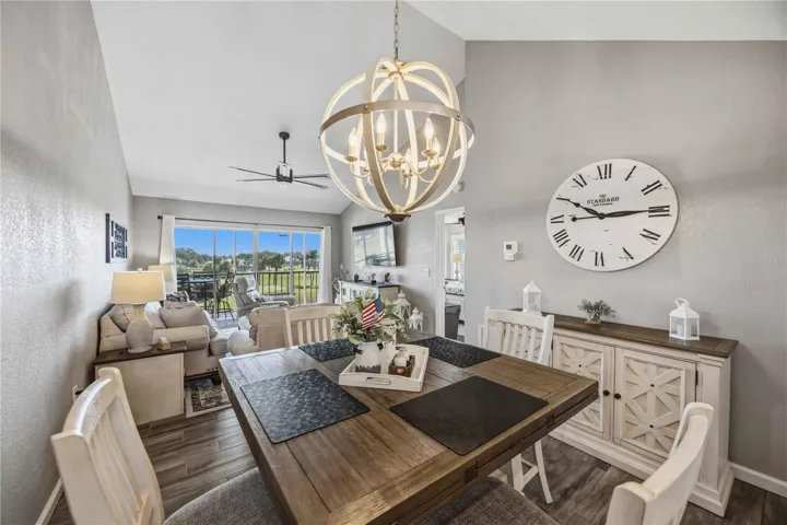 Open-concept living and dining spaces draw the eye toward expansive windows and the scenery beyond.
