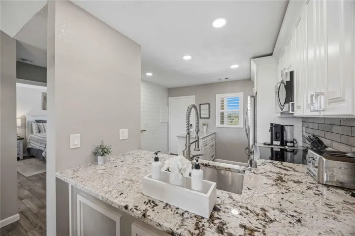 Granite-topped peninsula provides additional prep space and a natural connection between the kitchen and living areas.